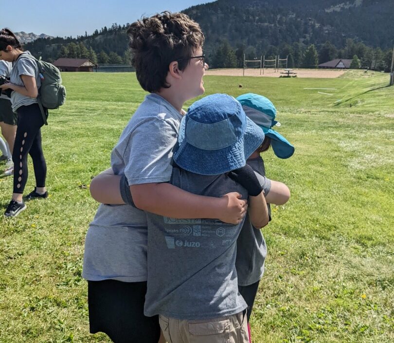 Hunter, Bryce, and Kyle hug outside.