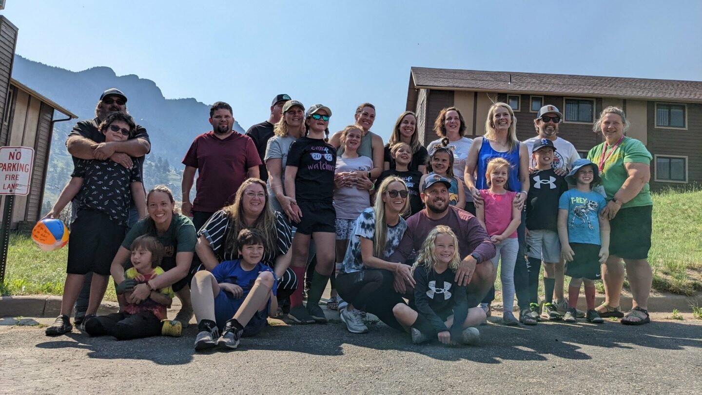 Campers and their family members smile together.