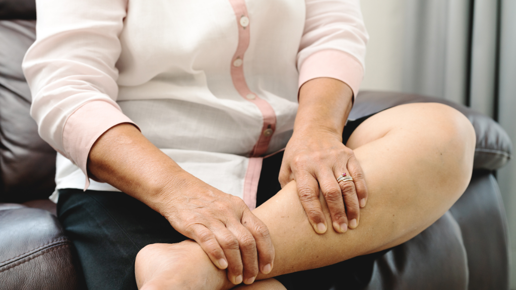 Person therapeutically massaging lower leg