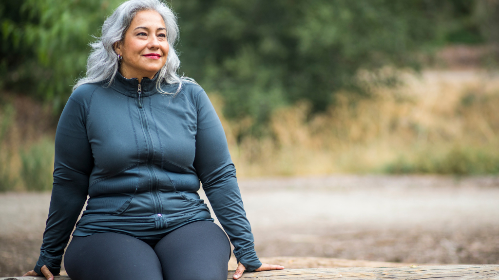 Older woman sitting outside and smiling