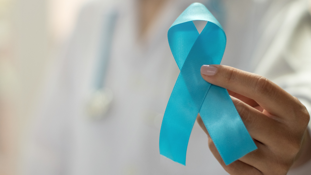 A doctor holds up a blue awareness ribbon to represent lymphedema.